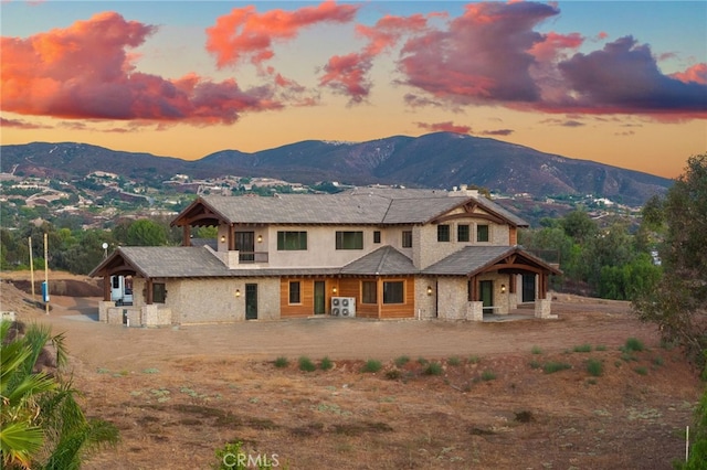 back house at dusk featuring a mountain view