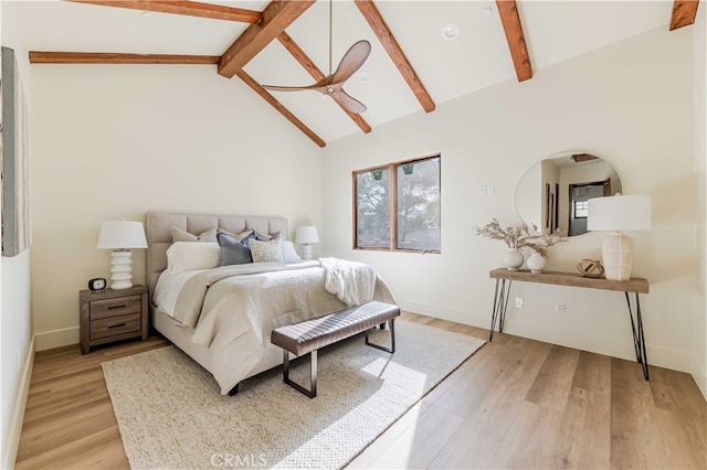 bedroom with ceiling fan, high vaulted ceiling, beam ceiling, and light hardwood / wood-style floors