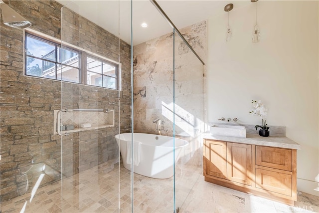 bathroom featuring vanity, shower with separate bathtub, and tile walls