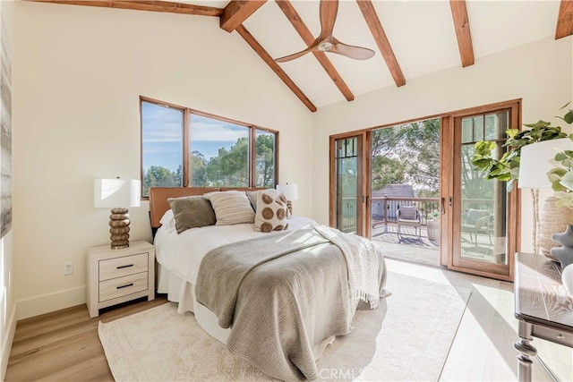 bedroom with light hardwood / wood-style floors, multiple windows, beam ceiling, and access to exterior