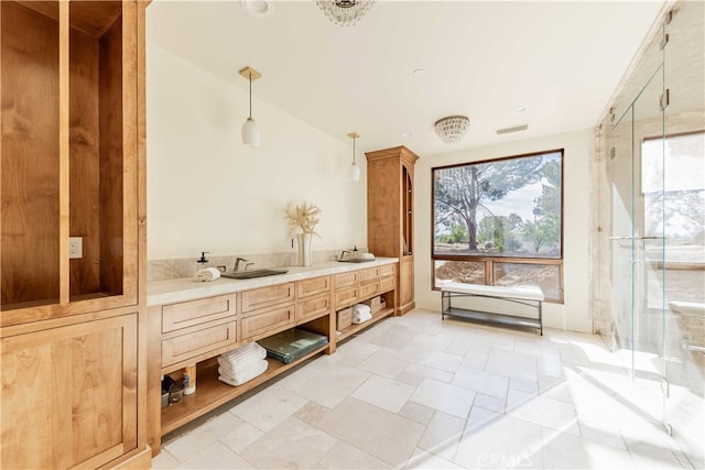 bathroom featuring vanity and an enclosed shower