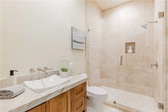 bathroom featuring vanity, a shower with shower door, toilet, and tile patterned flooring