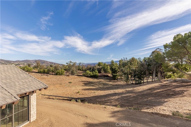 view of yard featuring a rural view and a mountain view