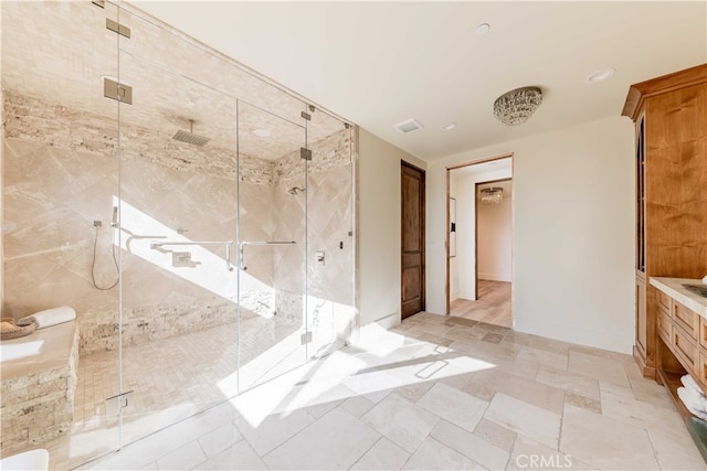 bathroom with a shower with door and vanity