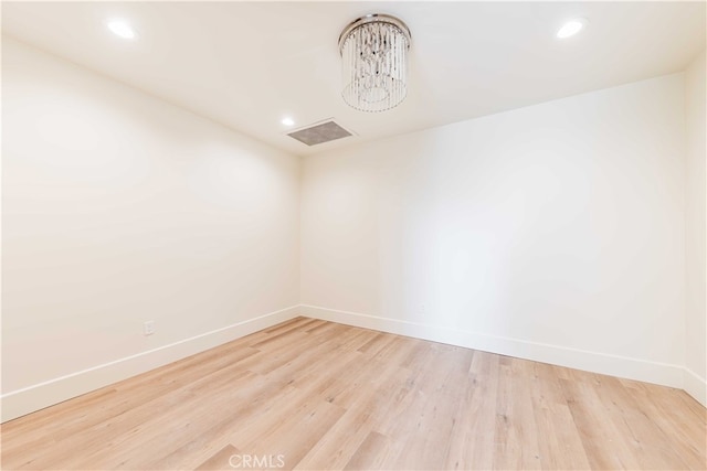 spare room featuring light hardwood / wood-style floors