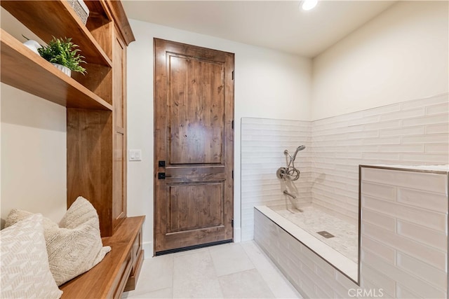 bathroom featuring a shower and tile patterned flooring