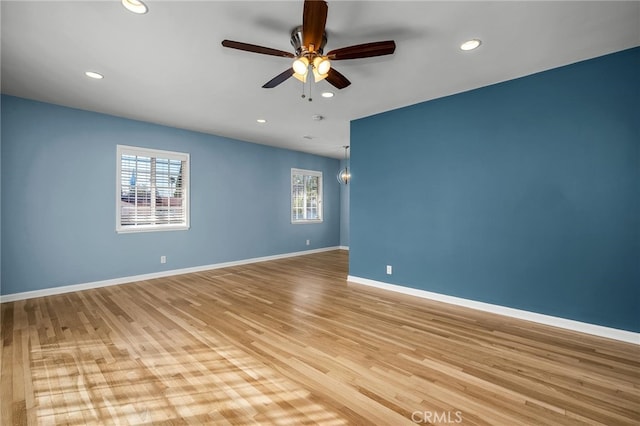 empty room featuring ceiling fan and light hardwood / wood-style flooring