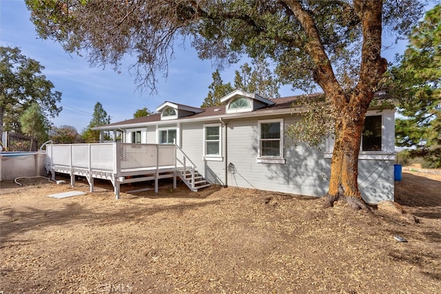 back of house with a wooden deck