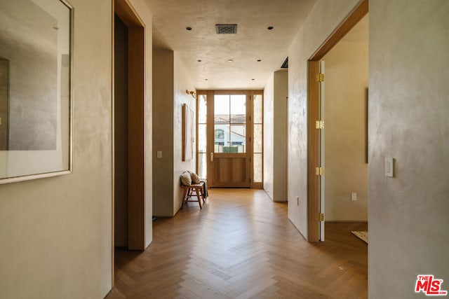 corridor with light parquet flooring