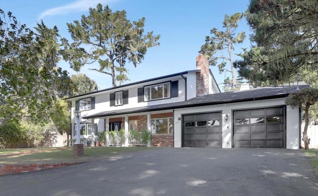 view of front of property with covered porch and a garage