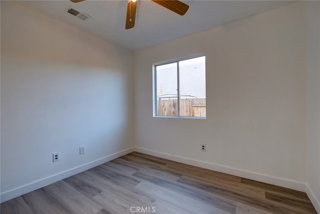 empty room with light wood-type flooring and ceiling fan