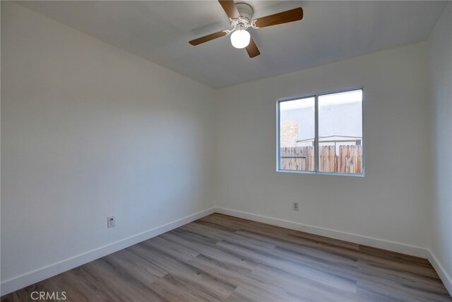 unfurnished room featuring light hardwood / wood-style flooring and ceiling fan