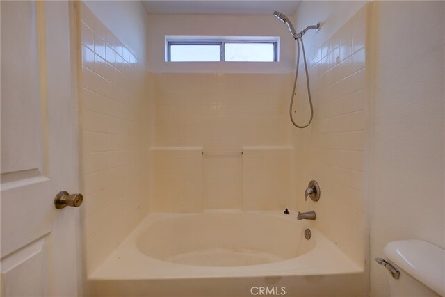 bathroom with toilet and shower / washtub combination