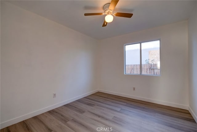 empty room featuring ceiling fan and light wood-type flooring