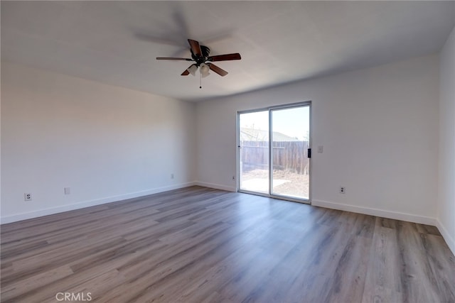 empty room featuring light wood-type flooring and ceiling fan