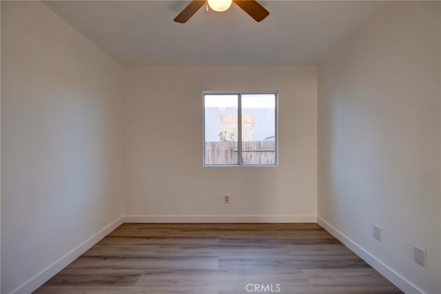 spare room with ceiling fan and light wood-type flooring