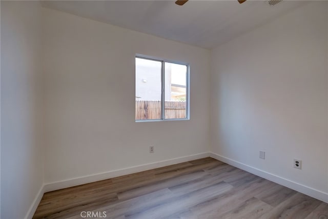 empty room featuring ceiling fan and light wood-type flooring