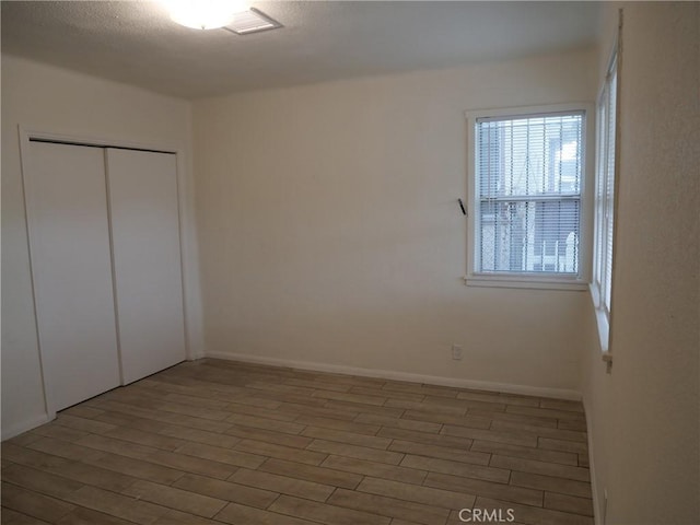 unfurnished bedroom featuring hardwood / wood-style floors and a closet