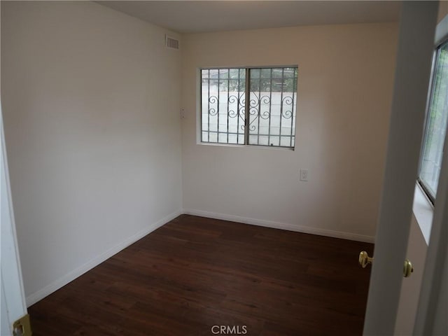 spare room with dark hardwood / wood-style floors