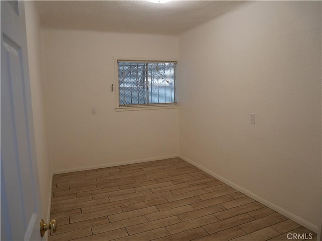 spare room with hardwood / wood-style floors