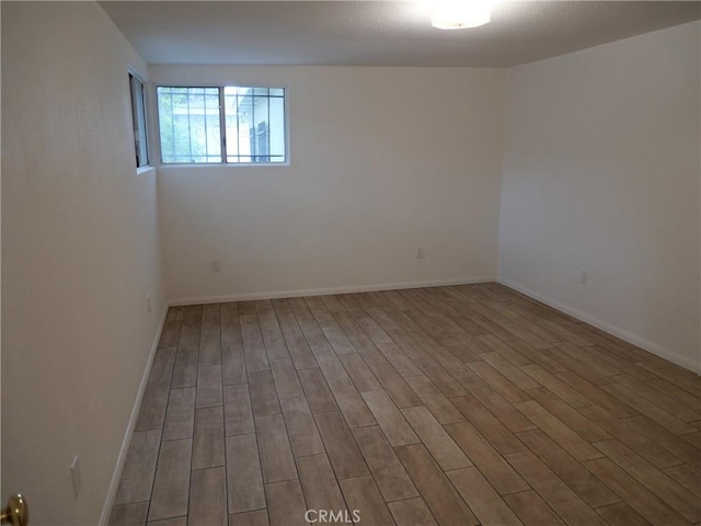 unfurnished room with wood-type flooring