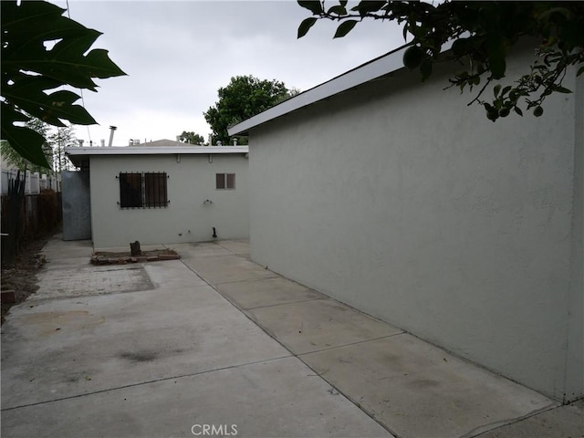 view of side of home with a patio area