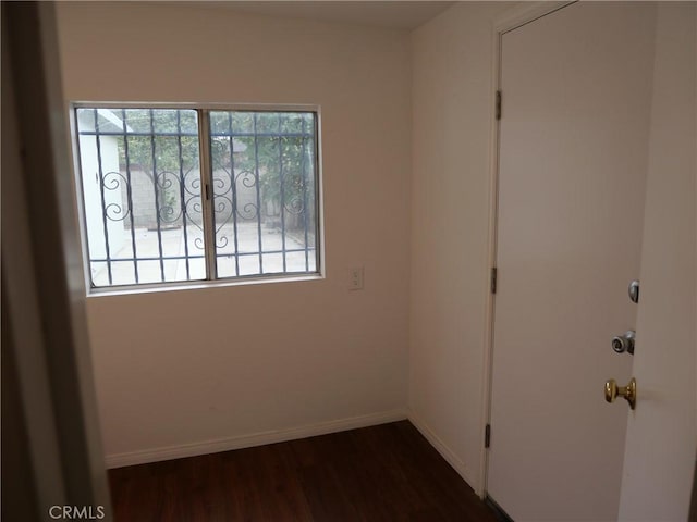 spare room with dark hardwood / wood-style flooring