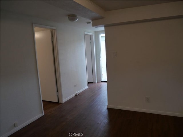 spare room featuring dark hardwood / wood-style flooring