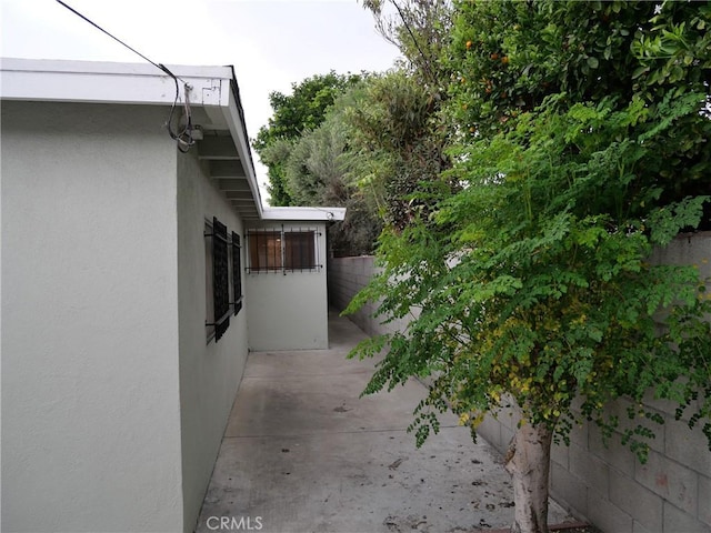 view of side of property featuring a patio area