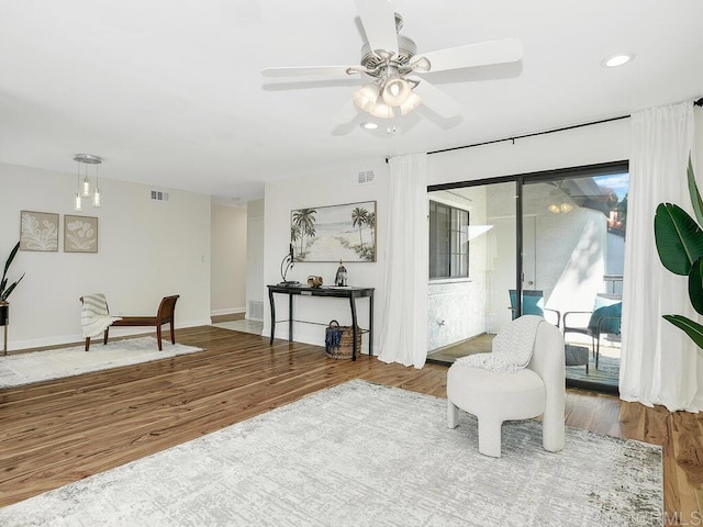 sitting room featuring ceiling fan and wood-type flooring