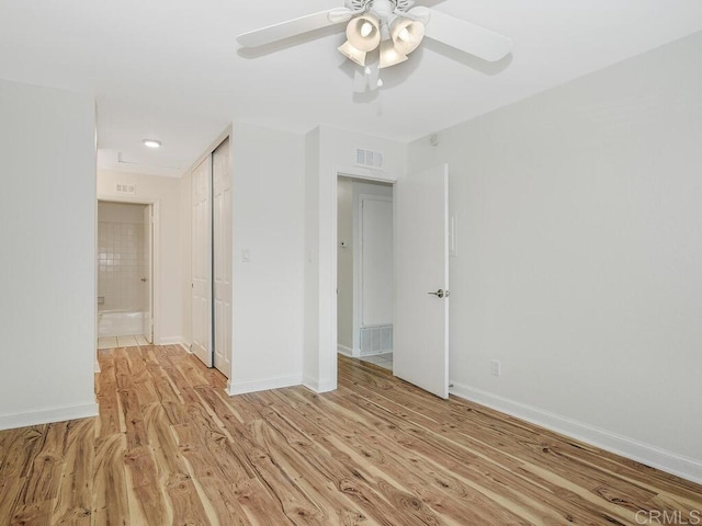 unfurnished bedroom featuring light hardwood / wood-style flooring, a closet, and ceiling fan