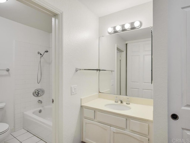 full bathroom featuring vanity, toilet, tile patterned floors, and tiled shower / bath combo