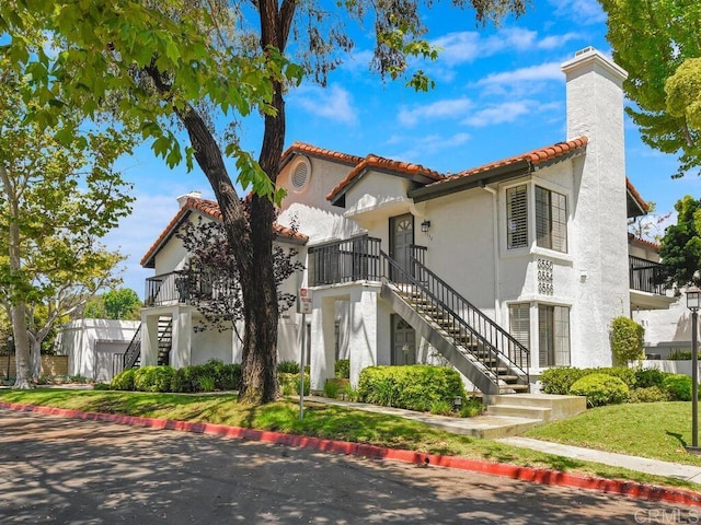 mediterranean / spanish-style home with a front yard