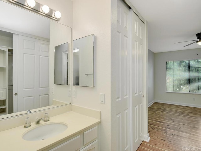 bathroom featuring vanity, hardwood / wood-style flooring, and ceiling fan