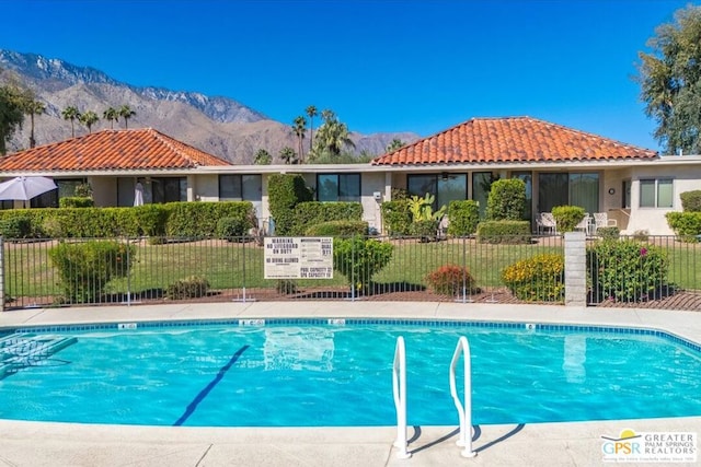 view of swimming pool with a mountain view