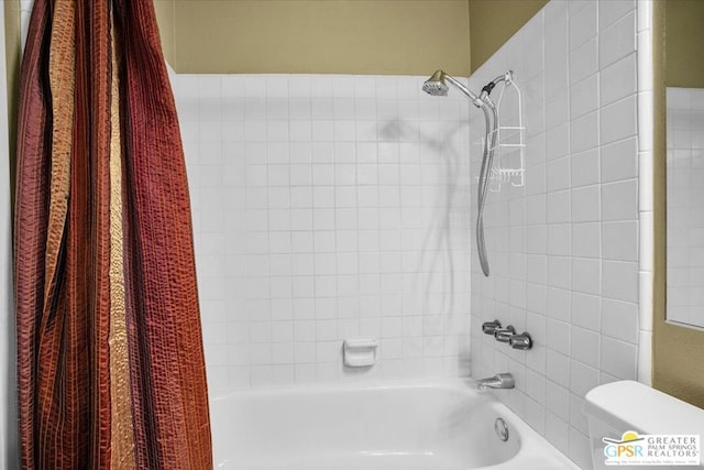 bathroom featuring toilet and shower / bath combo with shower curtain