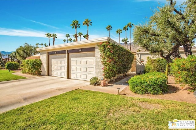 view of front of property with a front yard and a garage