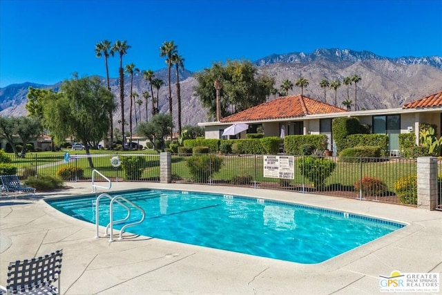 view of pool featuring a patio area and a mountain view