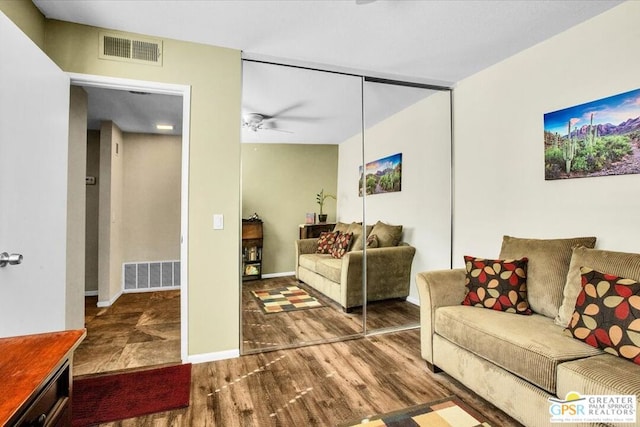 living room with hardwood / wood-style floors and ceiling fan