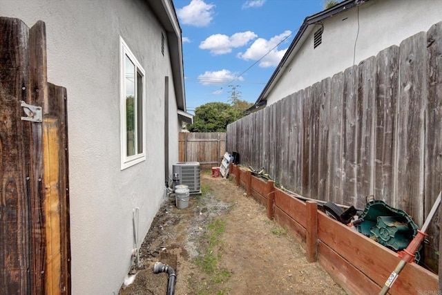 view of side of home with central AC