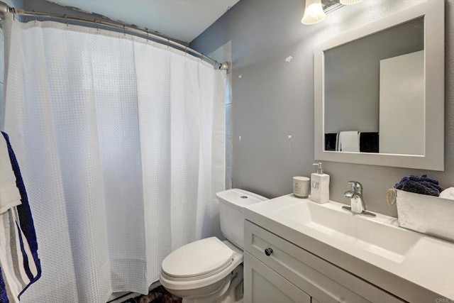 bathroom featuring walk in shower, vanity, and toilet