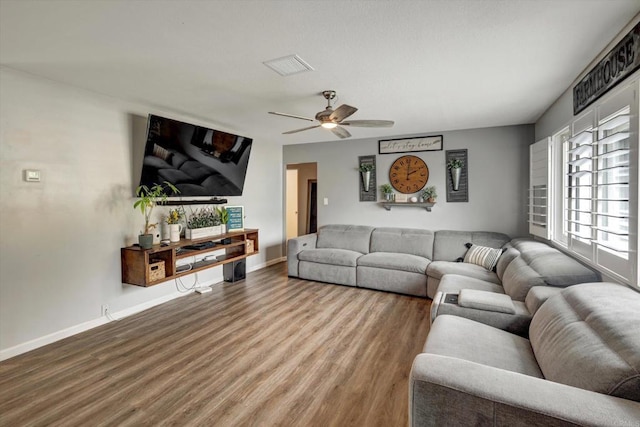 living room with wood-type flooring and ceiling fan