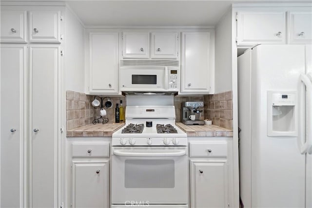 kitchen featuring white cabinets, white appliances, tasteful backsplash, and tile counters