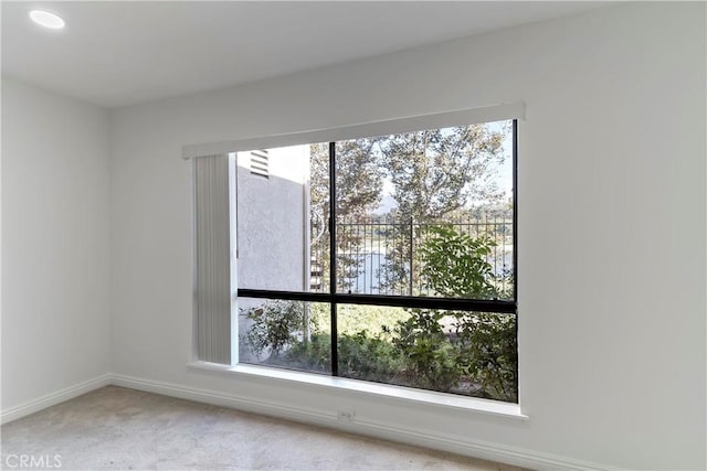 carpeted empty room with a wealth of natural light