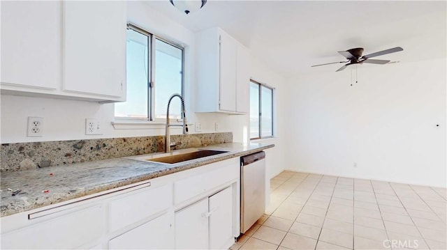 kitchen with white cabinetry, ceiling fan, light tile patterned flooring, stainless steel dishwasher, and sink