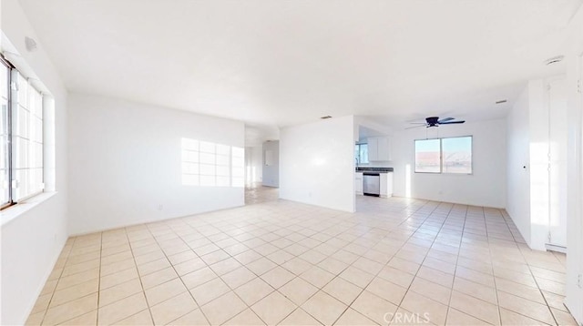 tiled empty room featuring ceiling fan