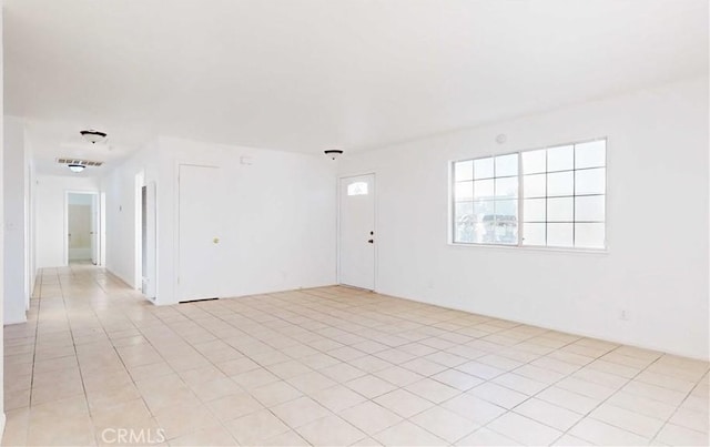 spare room with light tile patterned floors