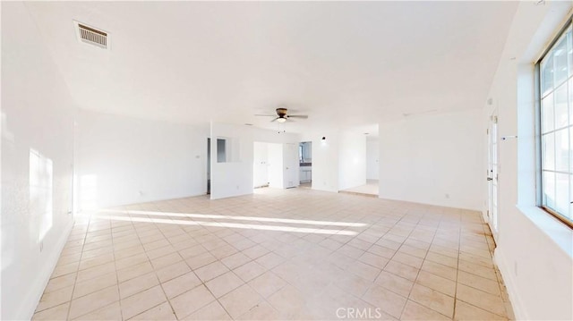 tiled empty room with ceiling fan