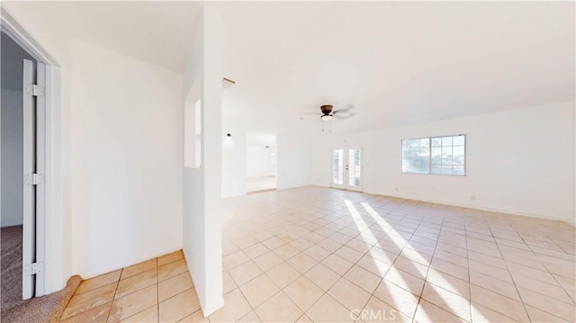 unfurnished room with ceiling fan and light tile patterned floors