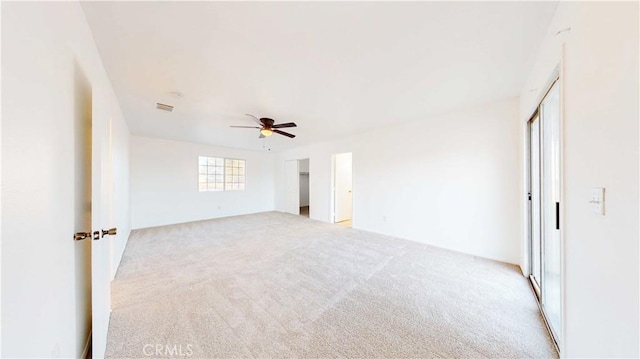 unfurnished bedroom with light carpet and ceiling fan